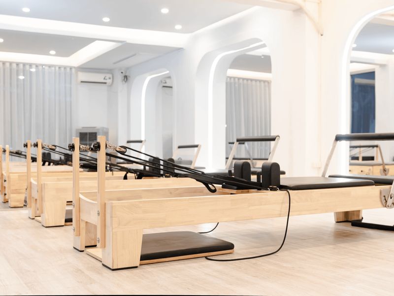 Spacious minimalist fitness studio with warm ivory lighting